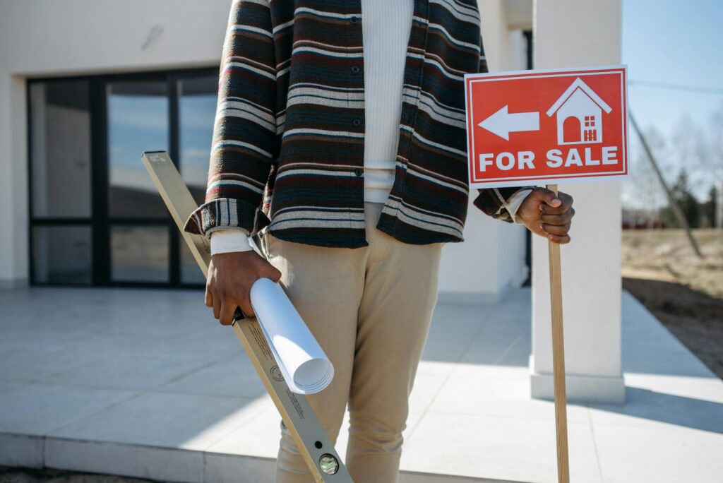 for sale sign infront home.